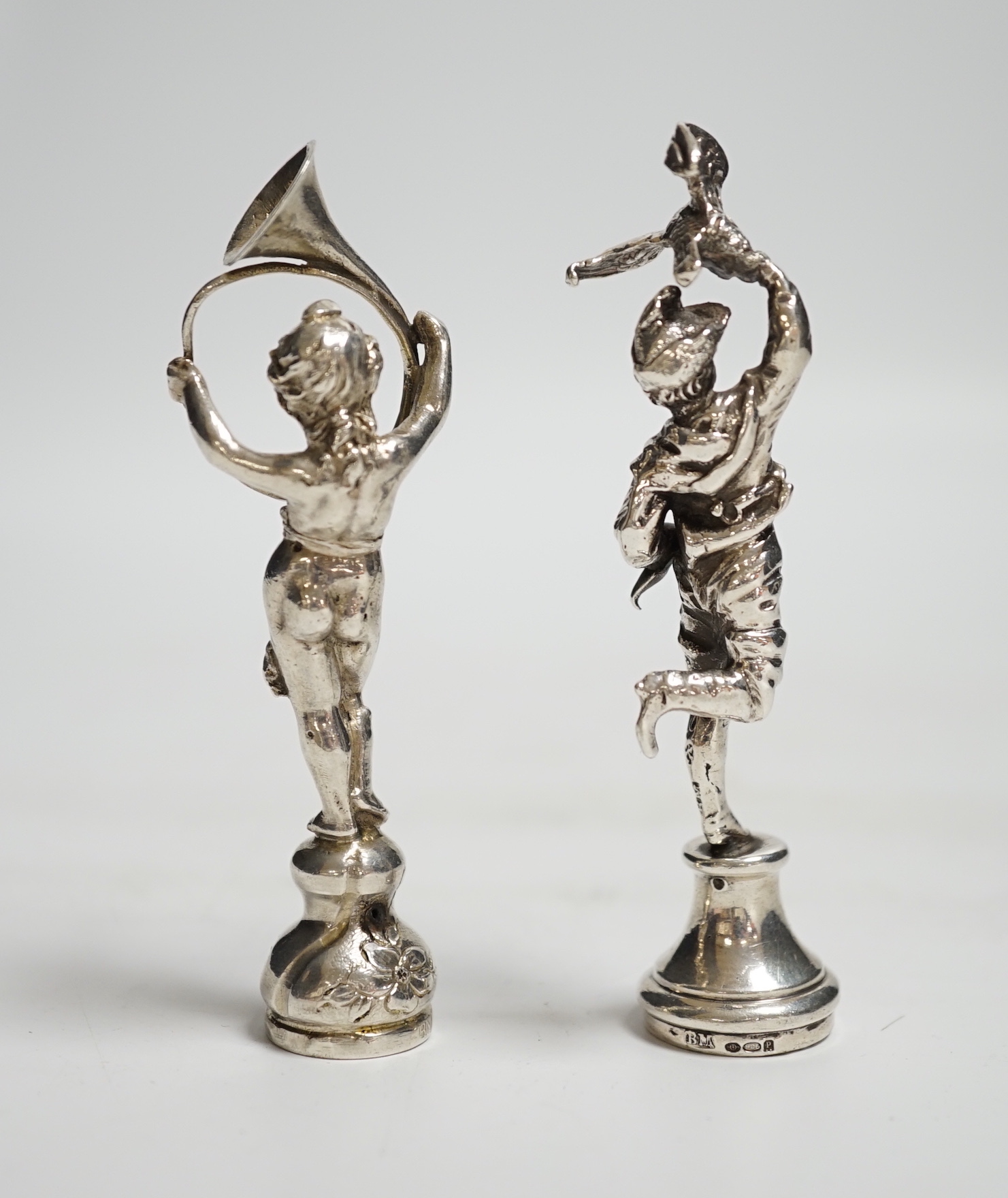 Two silver figural seals, child with French horn, import marks for Berthold Muller, London, 1894, 9cm and gentleman with eagle and crossbow, Berthold Muller, London, 1910.